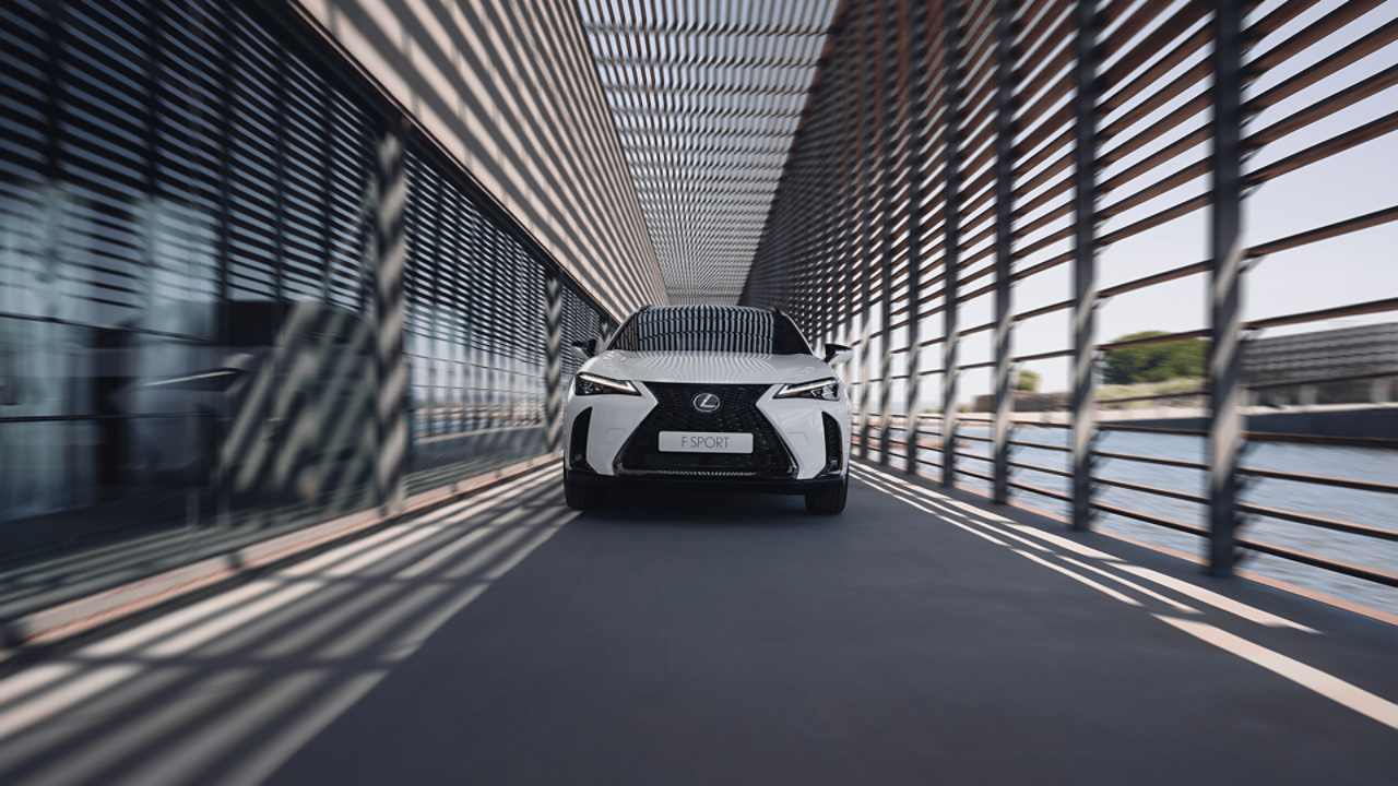 Lexus UX driving in a city location 