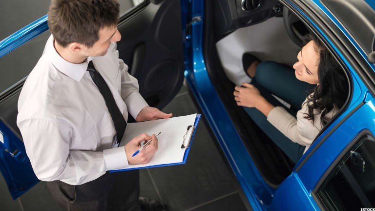 A woman driving a Lexus